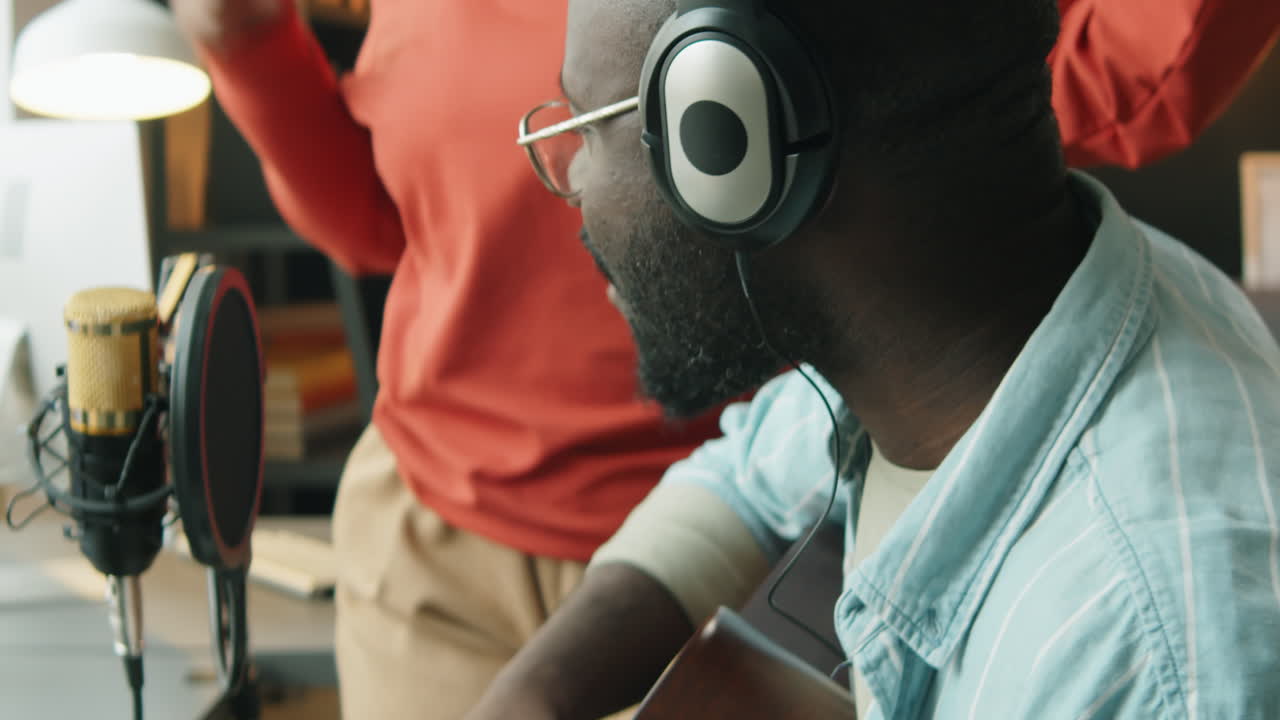 African American Couple Recording Song Together at Home Studio
