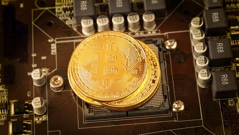 Gold Bit Coin BTC coins on the motherboard. Bitcoin is a worldwide cryptocurrency and digital payment system called the first decentralized digital currency.