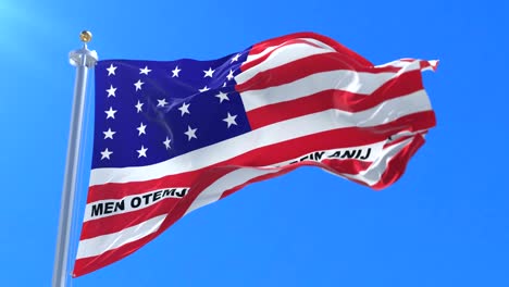 flag of bikini atoll, member of the marshall islands, waving at wind in slow with blue sky, loop