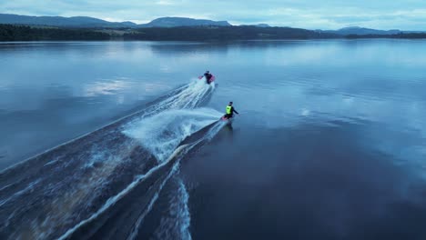 a kneeboarder doing a surface 360 trick behind speed boat