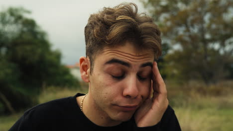 boy yawns tired in the nature after a day of work in the countryside