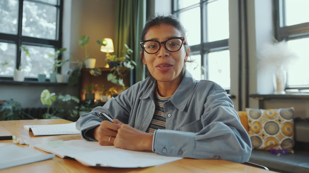 Hispanic Woman Talking on Camera via Video Call during Online Class