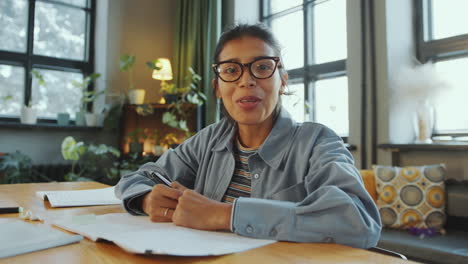 hispanic woman talking on camera via video call during online class