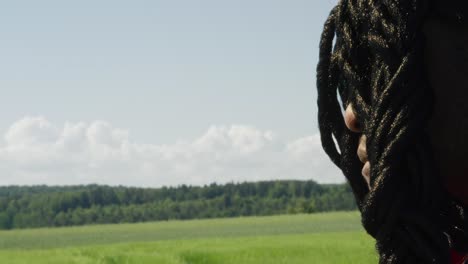 samson looking around towards screen while staring out at green landscape, biblical character with long dreads, israelite warrior and judge, black male in old testament, christian