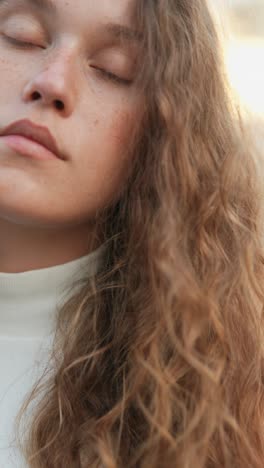 close-up portrait of a young woman with curly hair