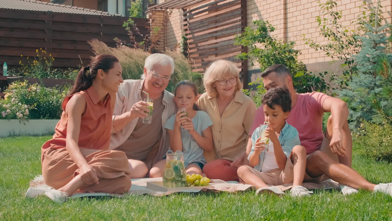 Big Family Having Picnic In Backyard