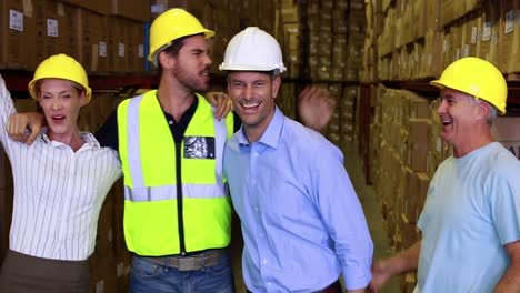 Warehouse-team-smiling-and-high-fiving-each-other