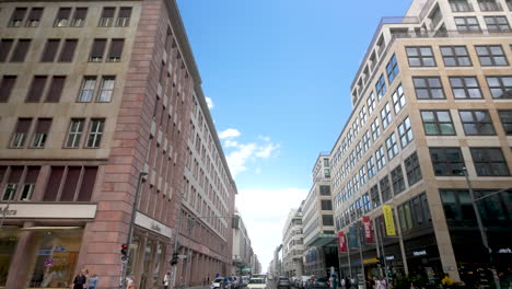 city street scene with people walking and bicycling