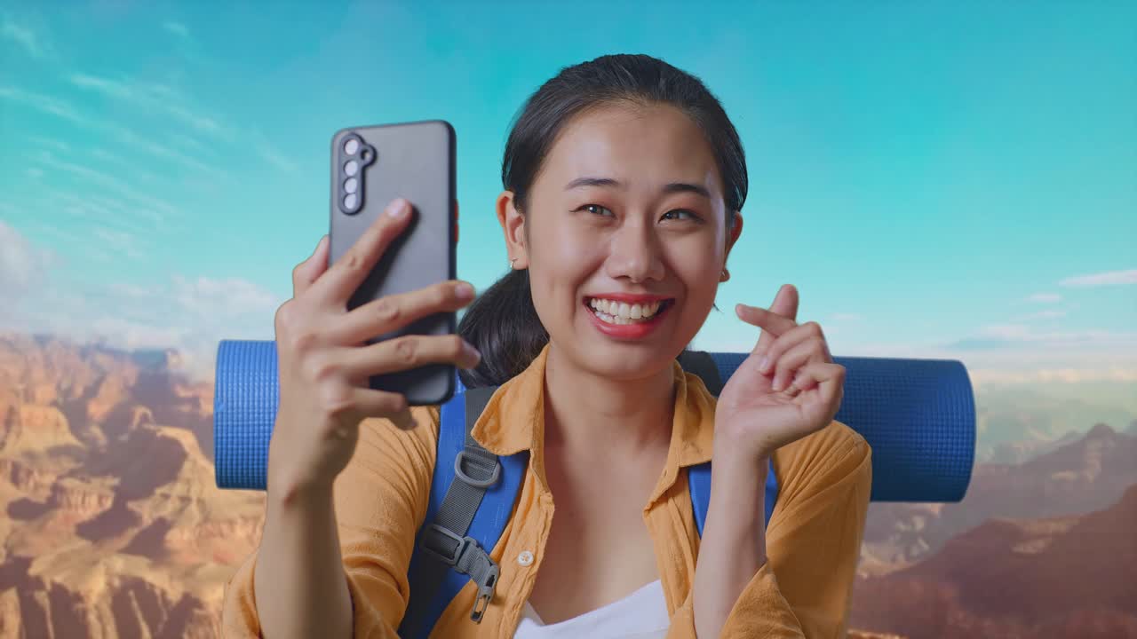 Close Up Of Asian Female Hiker With Mountaineering Backpack Taking A Selfie While Traveling At The Top Of Mountain