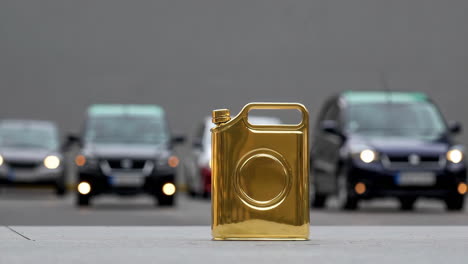 golden fuel can with cars in background