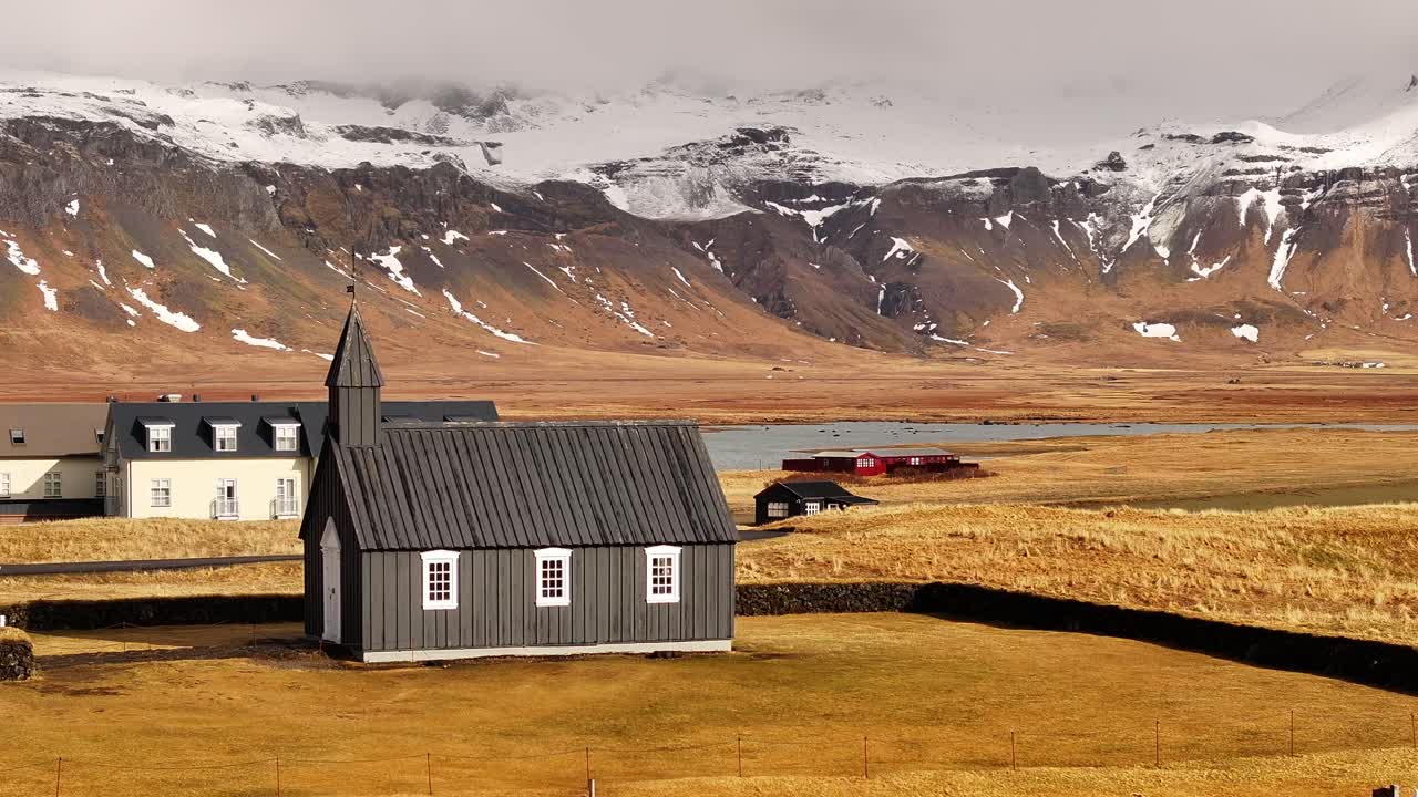 black church of Búðir faces misty Snæfellsnes mountains and calm Icelandic plains