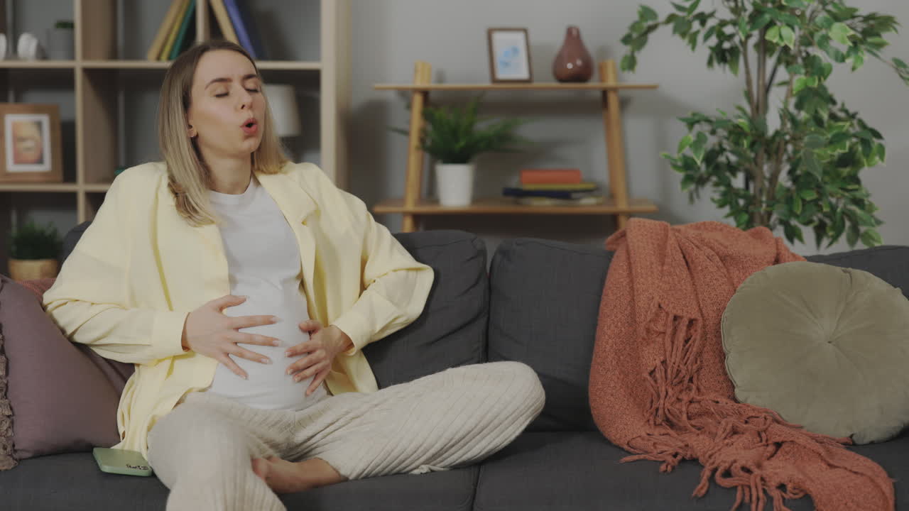 Pregnant woman reacting to something on her phone
