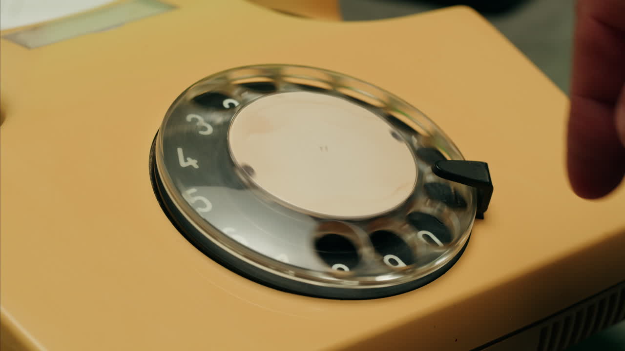 Retro vintage phone, A yellow rotary telephone is displayed on a wooden desk, adding a nostalgic touch