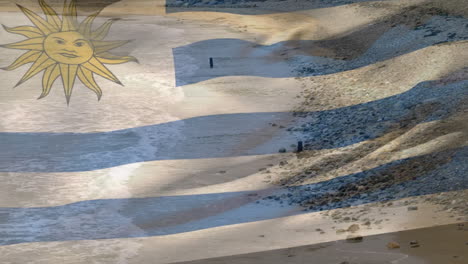 uruguay flag animation over beach with rocks and sand