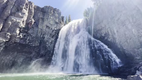 Beautiful-waterfall-glistening-in-the-sun-as-it-falls-over-stunning-rock-formations-in-mammoth-lakes-california