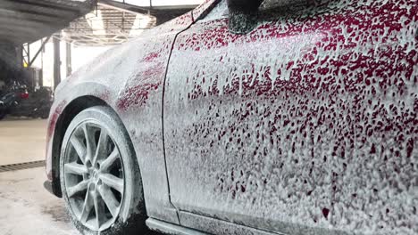 red car being foam washed