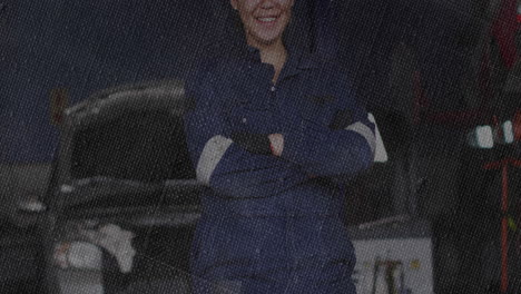 female mechanic crossing arms in auto repair bay, featuring animated gear icons and data charts