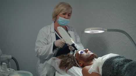 professional dermatologist doing peeling treatment in modern wellness clinic