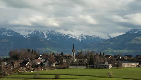 Church-in-a-small-village-with-beautiful-snowy-mountains-in-the-background