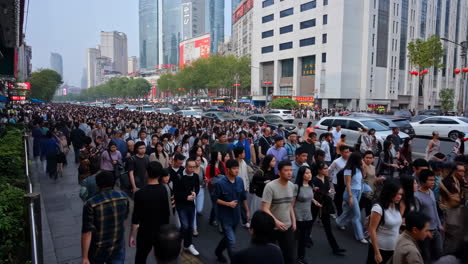 crowded city street with people and traffic