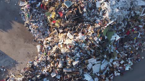 large pile of waste at a landfill site on a sunny evening