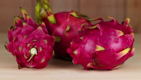 Vibrant dragon fruits arranged on a wooden surface