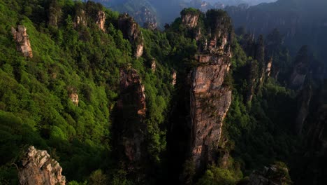 drone flying over karstic pillars in tianzi mountain at sunset with stunning views