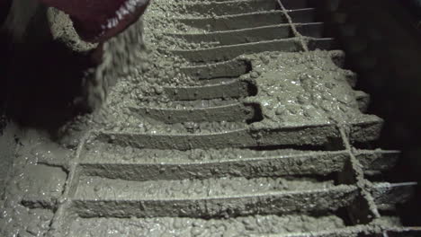 Machine-spewing-cement-or-concrete-on-a-metal-surface