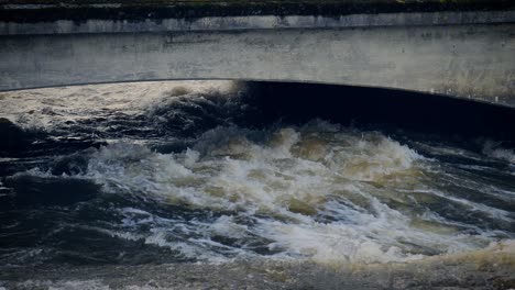 Close up view of water in Corrib river churning and rushing toward the sea in Galway, Ireland