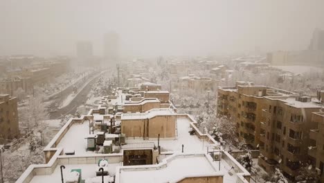 fly over buildings rooftop during the heavy snowfall in tehran iran