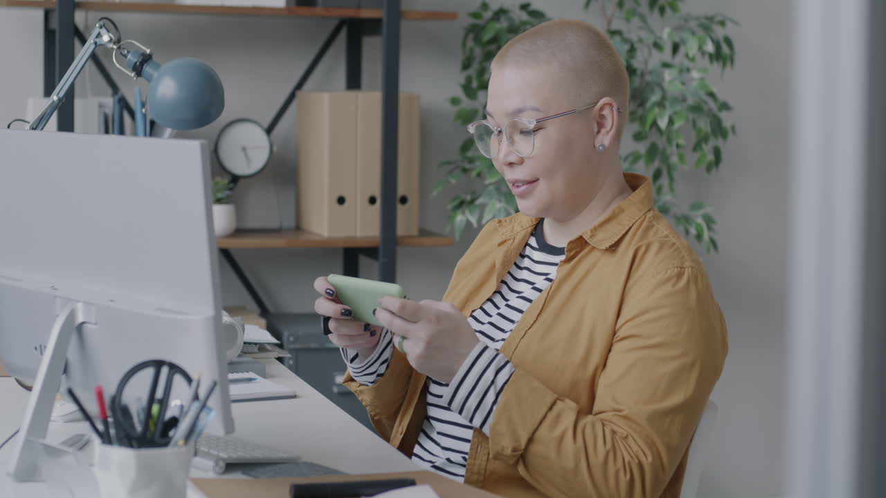 Woman using phone in office
