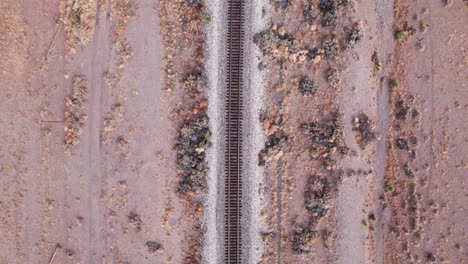 drone shot looking down on railroad tracks in the center of the video frame