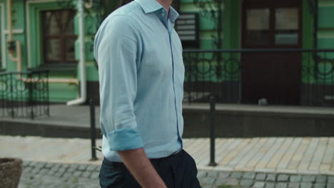 closeup man going on date with bouquet. man smelling red roses at paved road