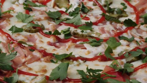 close-up of a ham and pickle pizza