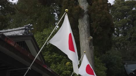 two japanese flags flying in slow motion at temple 4k