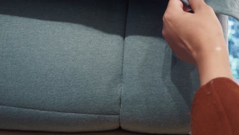 person checking the quality of a couch