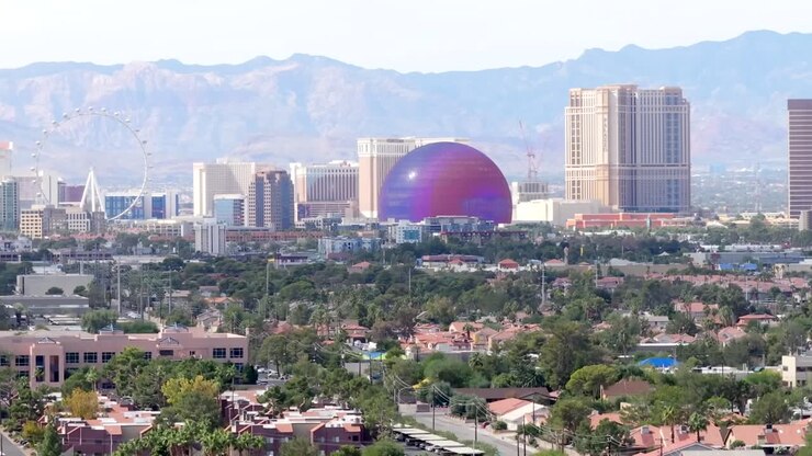 Las Vegas strip against the backdrop off the mountains - rising aerial reveal