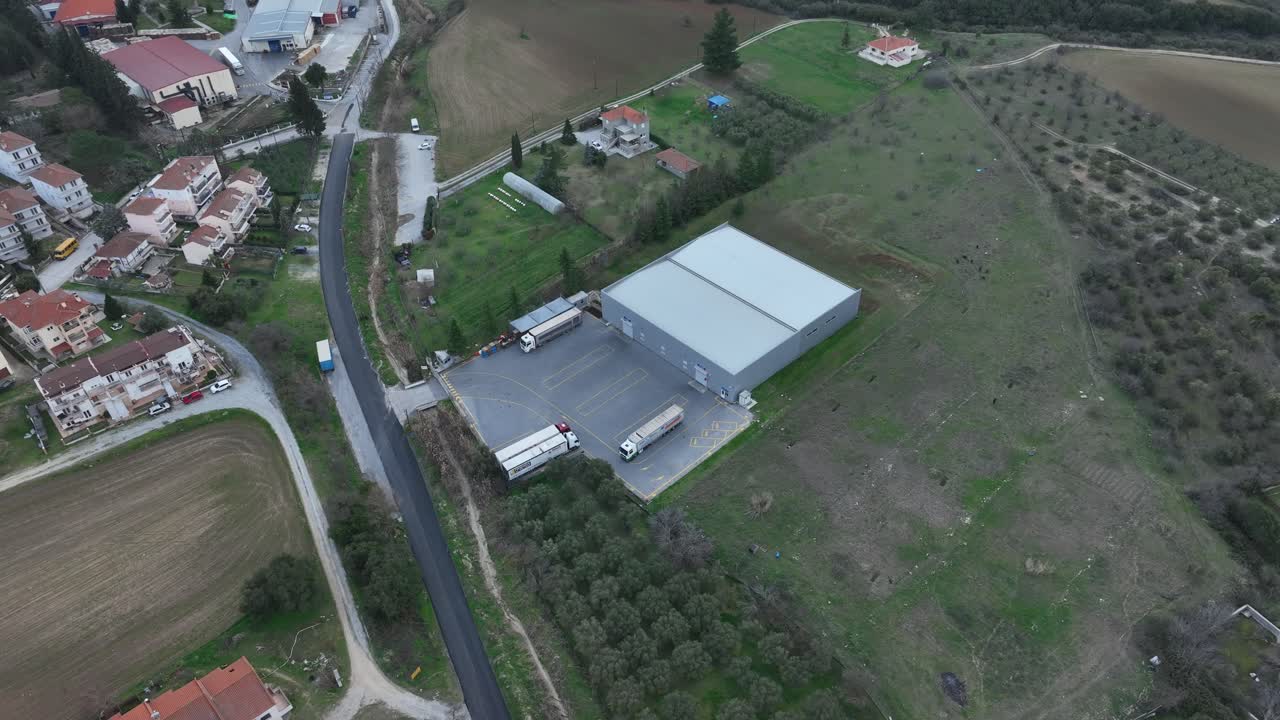 Local warehouse for water and soda production, important facility for economy. Panoramic overview with the neighbouring town