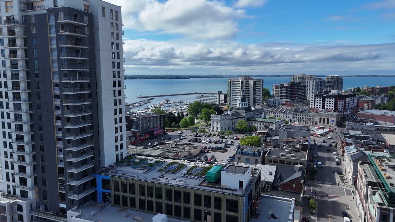 Cinematic 4K drone footage of downtown Kingston, Ontario, Canada. This aerial view showcases Kingston’s historic City Hall with updated modern condos and the vibrant downtown core in the background
