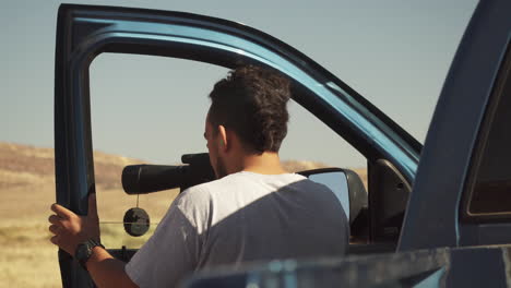 a-young-hunter-looks-into-the-spotting-scope-to-check-out-target-groupings