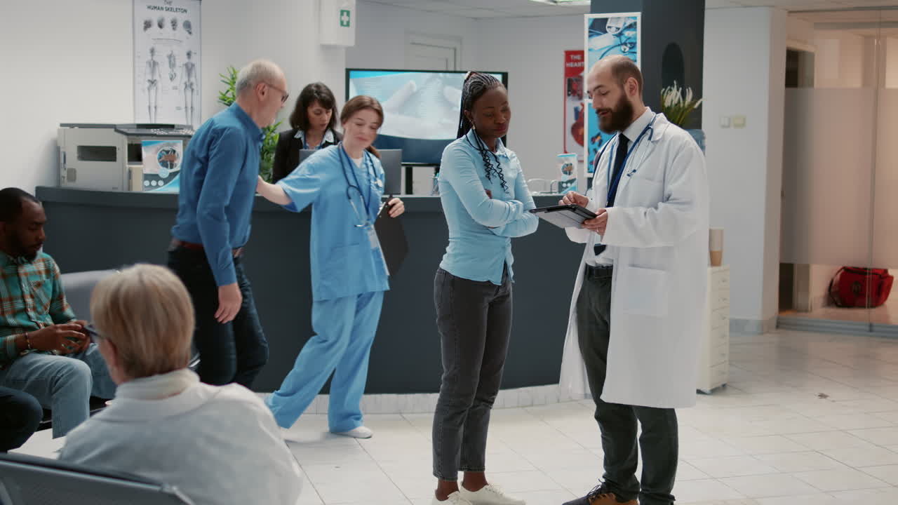 Doctor consulting with patient in hospital reception area