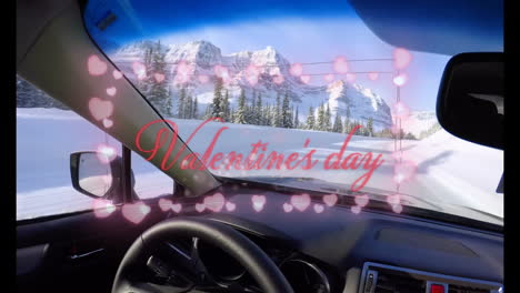 valentine's day text with heart animation over snowy mountain driving scene