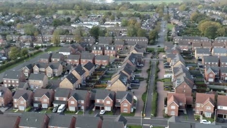Property ladder new British housing estate aerial view overlooking rooftops slow right orbit