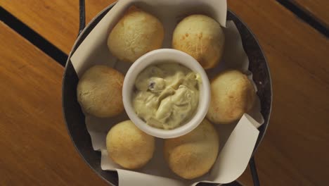 Rotating-chipa-snack-with-cheese-bread-and-aioli-dip,-close-up-shot