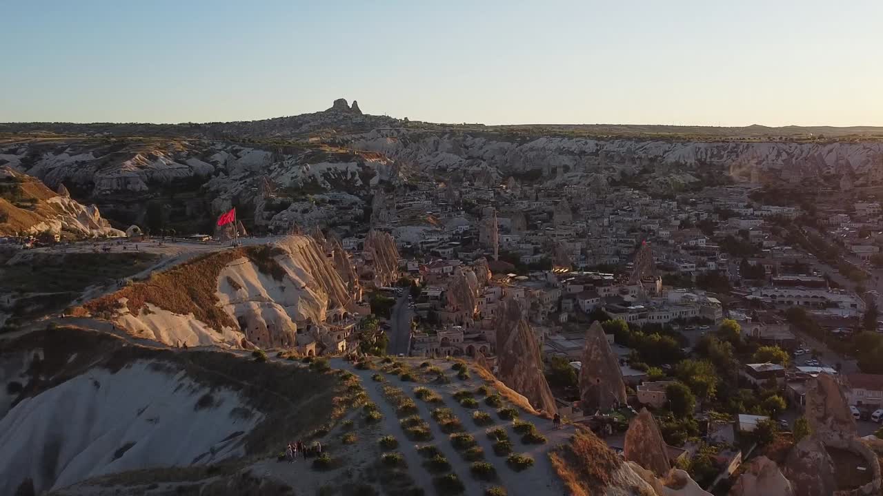 Aerial rising drone view from the viewpoint over G&ouml;reme town in Cappadocia during sunset
