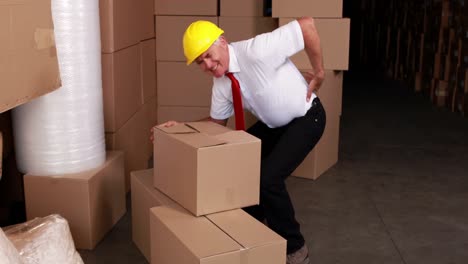 warehouse manager injuring his back moving boxes