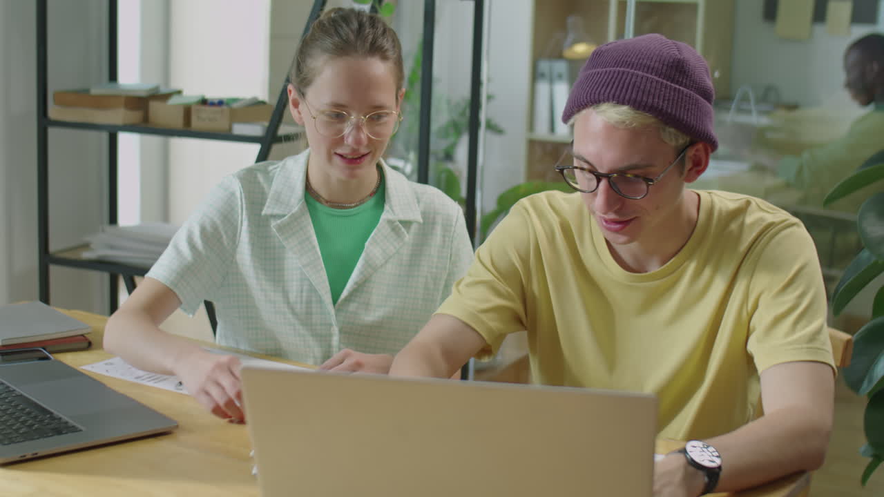 Gen Z Office Workers Using Laptop and Speaking