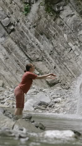 woman enjoying a waterfall in nature