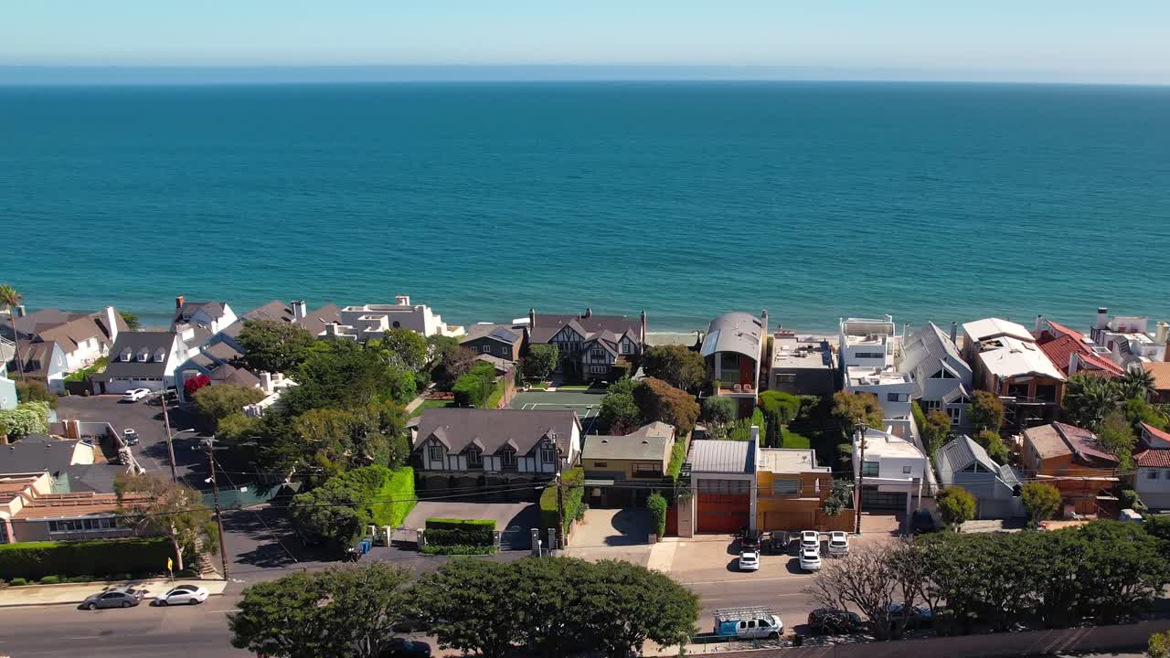 Splendida ripresa aerea con drone di case sul lungomare sulla spiaggia di Malibu sotto il sole estivo.