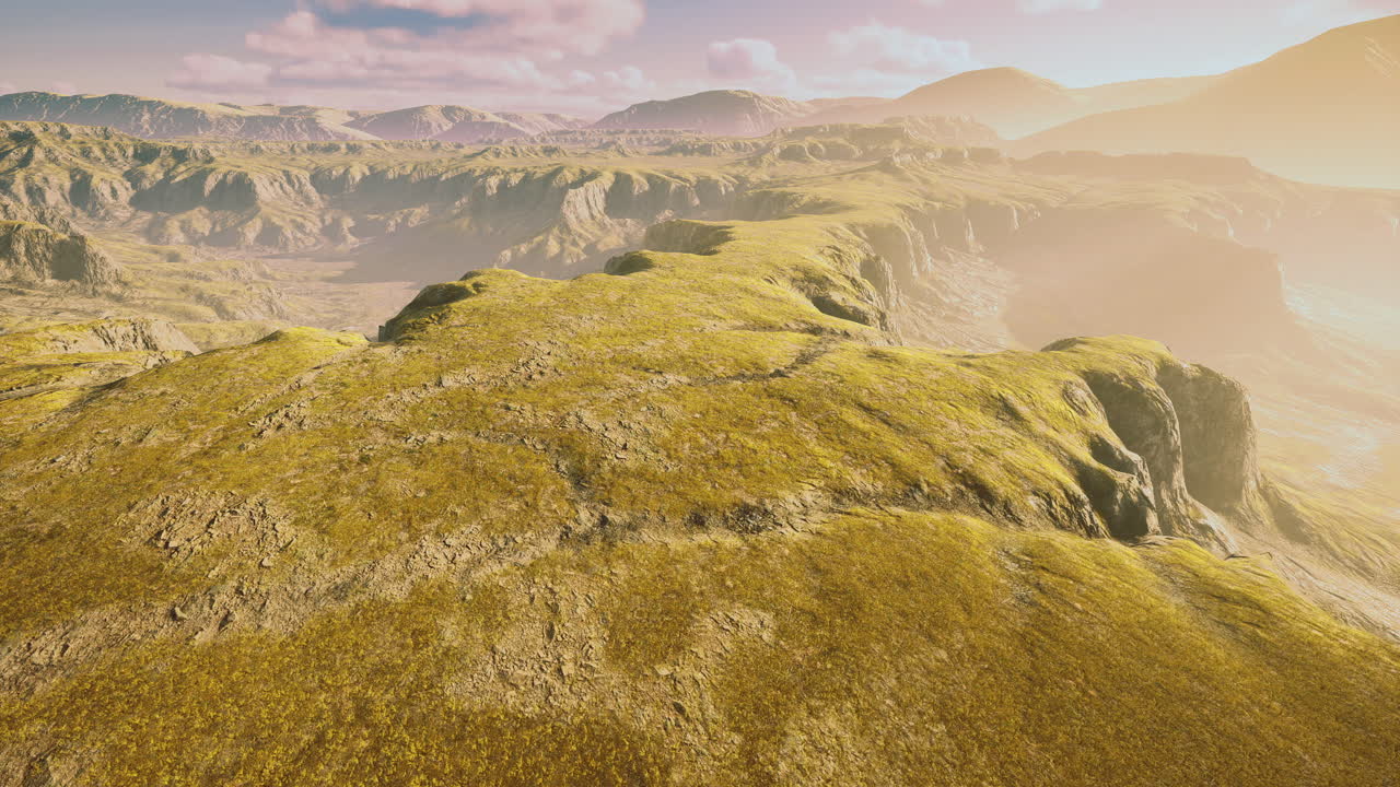 Vast expanse of rugged terrain illuminated by soft golden light